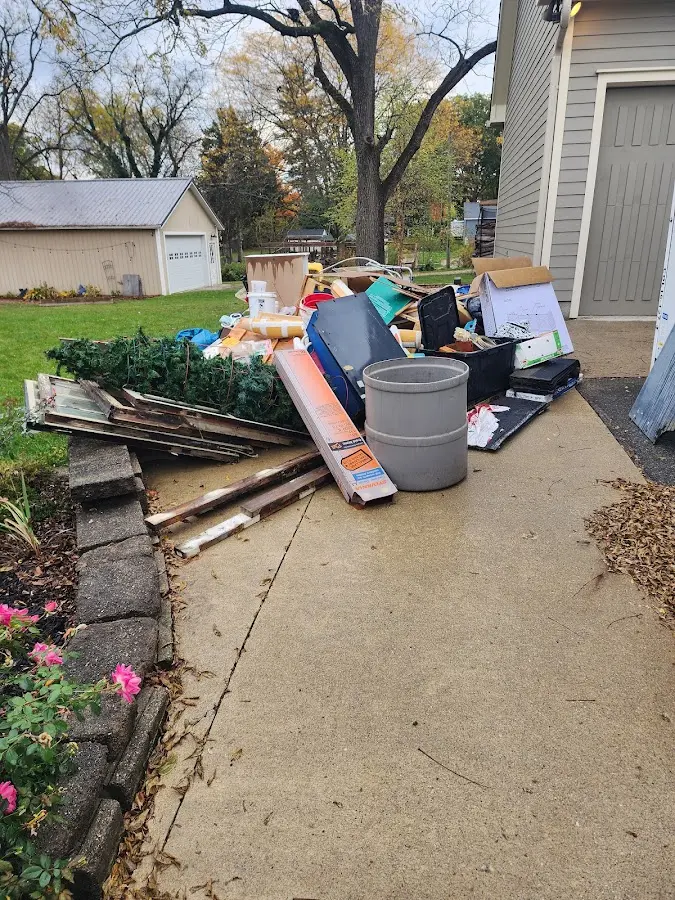 Dumpster being loaded with debris for Demolition Dumpster Rental in Siloam Springs